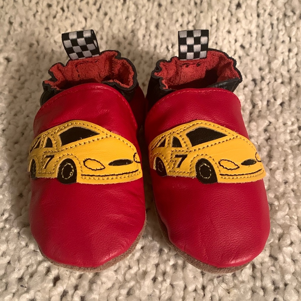 Robeez infant shoes, red with yellow race cars on them, 6-12 months.